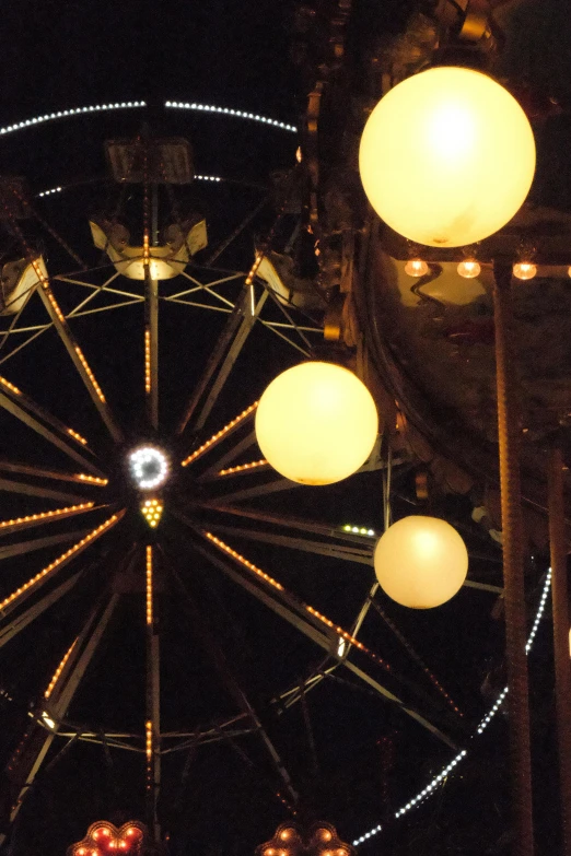 several balls are floating around a ferris wheel