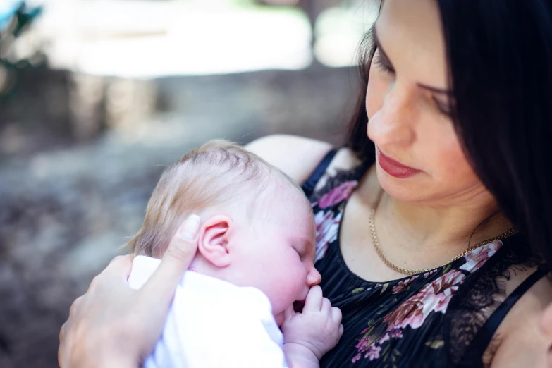 a baby being held by its mother