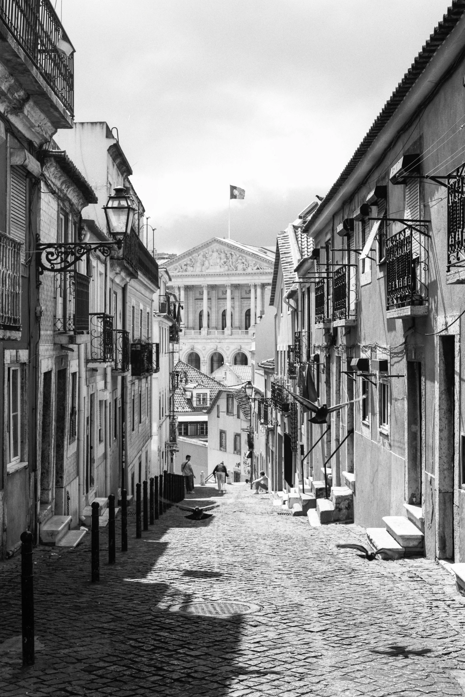 an empty street with some buildings and cobblestone streets