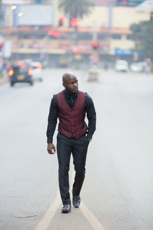 a man walks down the street in a vest