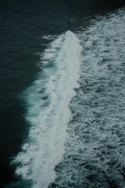 a surfer riding a wave near the shore