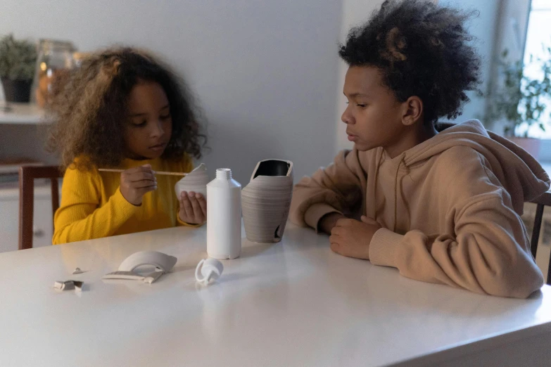 two young children eating lunch at a table