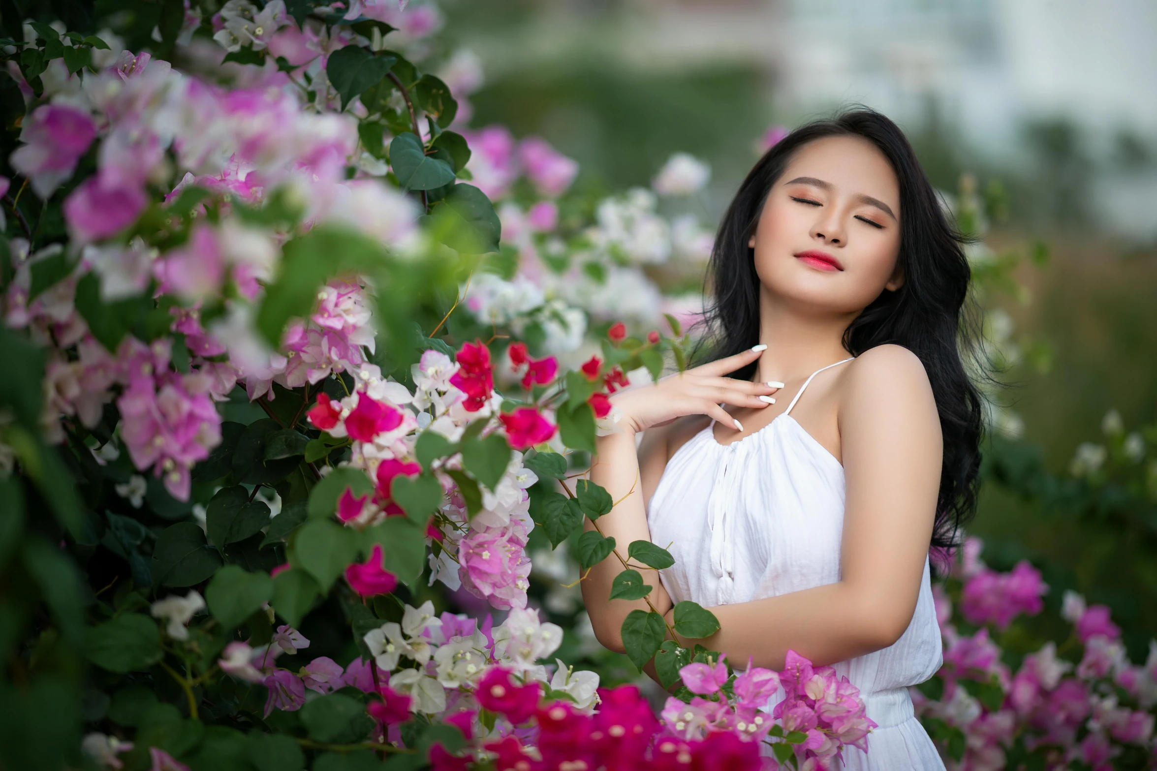 a young lady is posing for a pograph in flowers