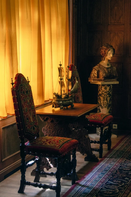 a room that has a table, a piano and a fancy chair