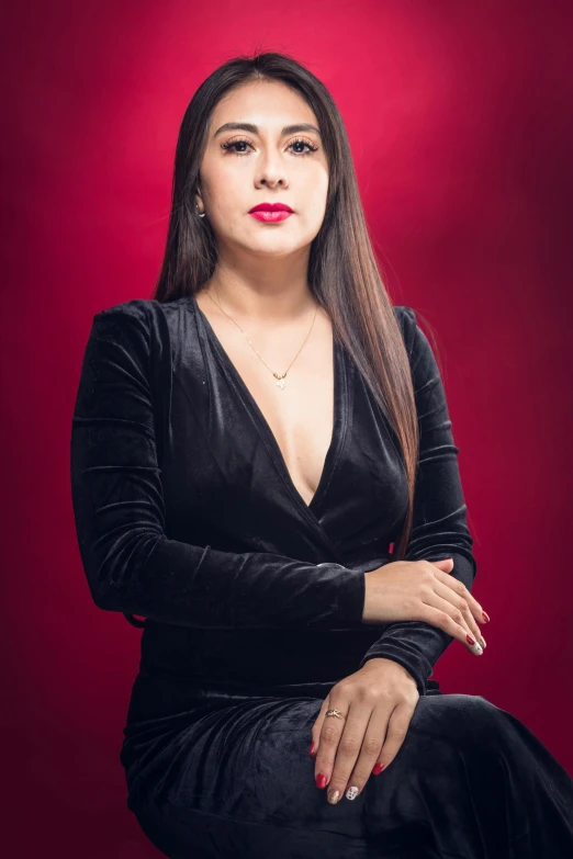 an indian woman wearing a black dress and red lipstick