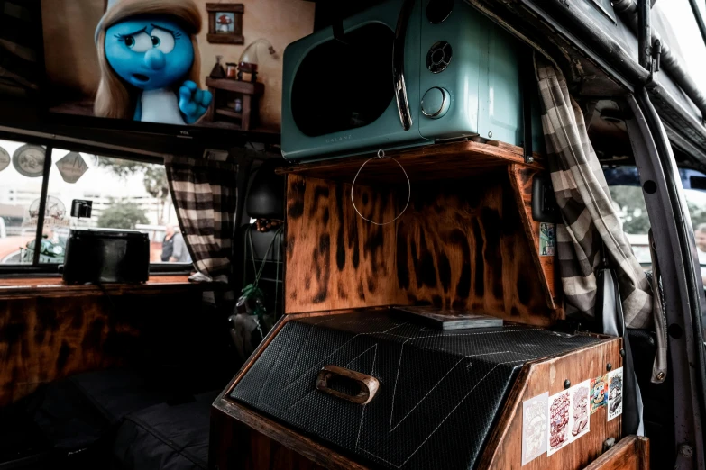 an old style stove is in the back of an abandoned bus