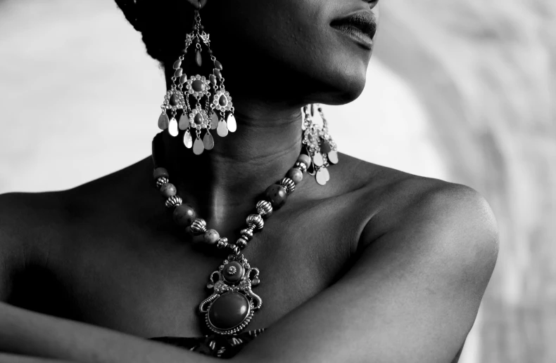 a black woman with multiple jeweled earrings on her neck