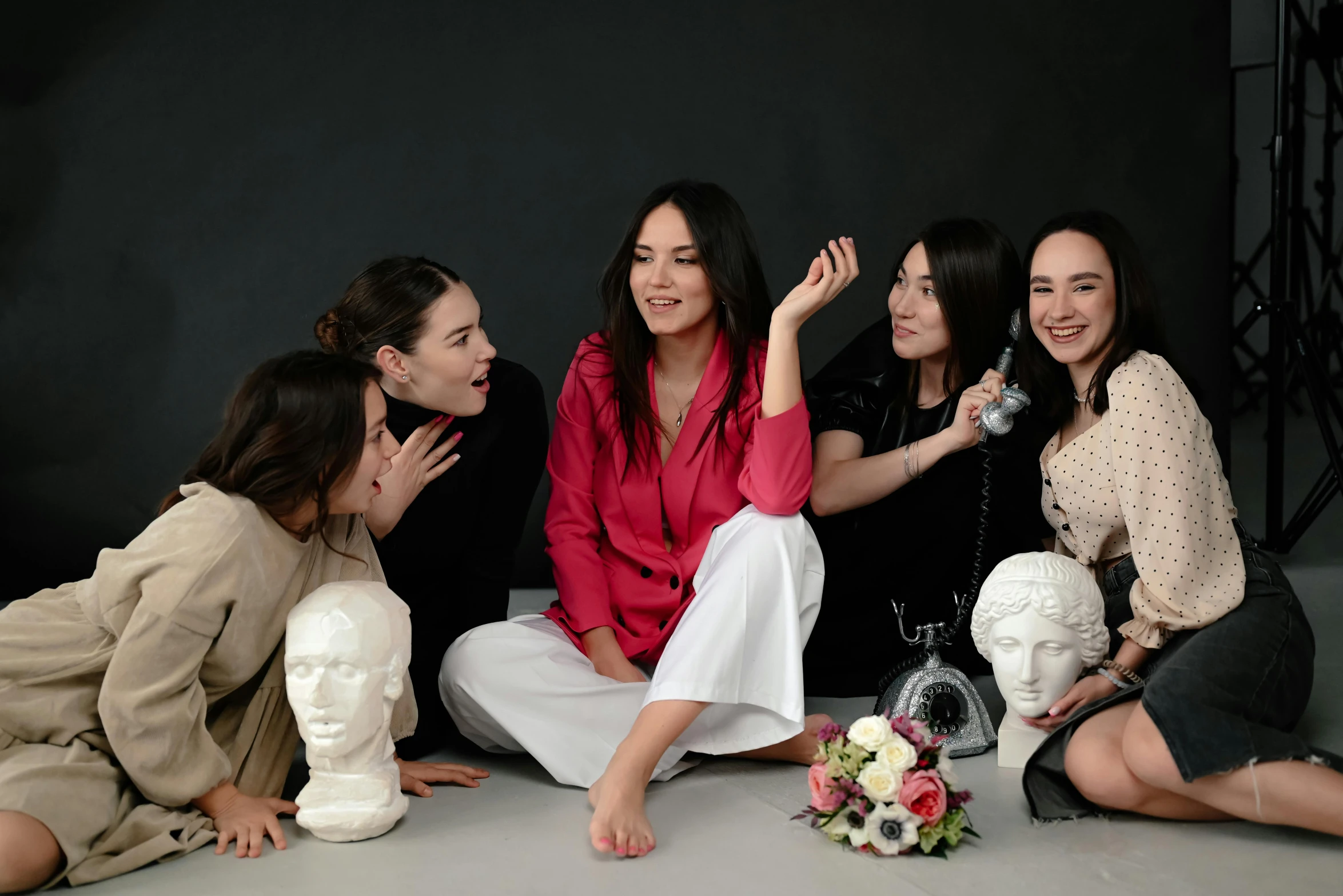 four girls sitting around and one touching her hand