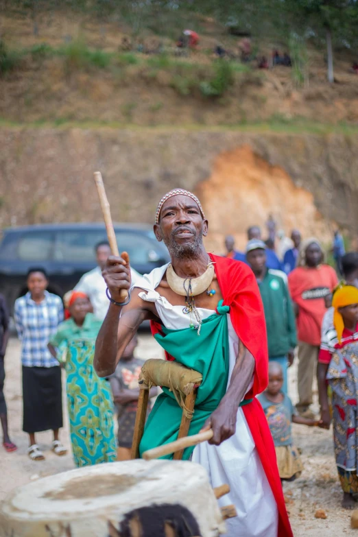 there is a man that is holding a stick