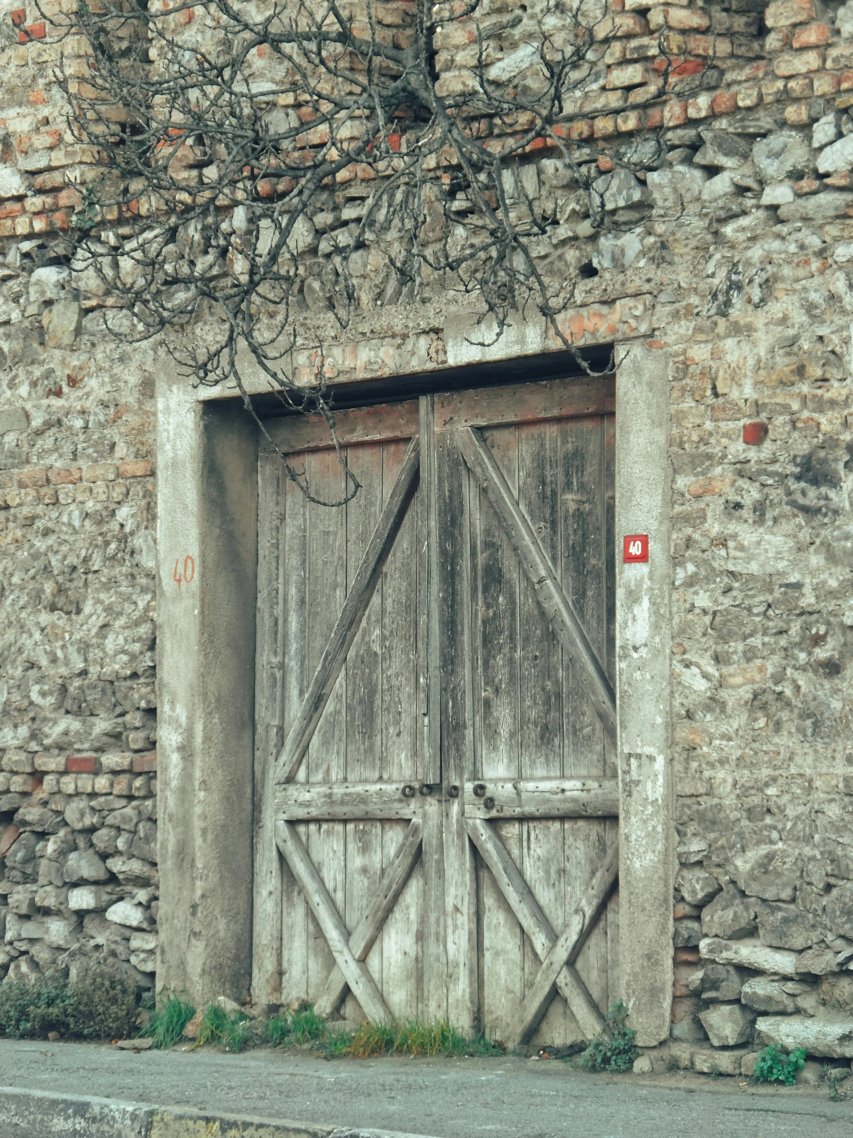 an old door is open on the outside of an ancient brick wall