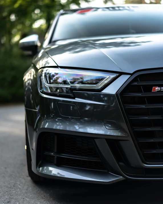 an audi vehicle parked on the road in the shade