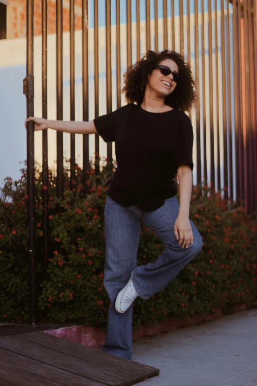 a person that is posing in front of some flowers