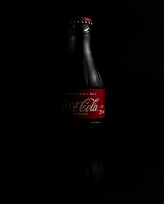 there is a black background with one bottle on top