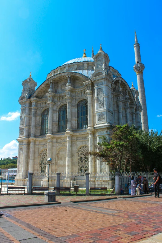 people are walking outside a building that looks like a mosque