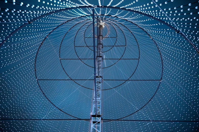 a large array of circular white lights against a dark blue background