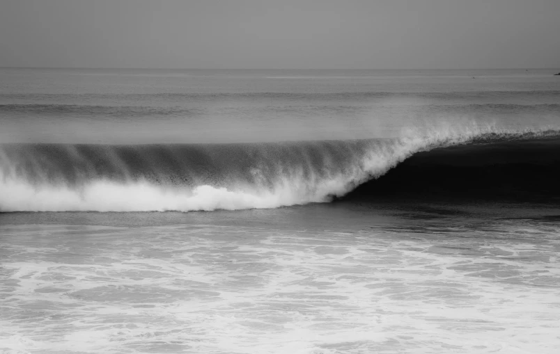 a surfer rides the waves in the ocean