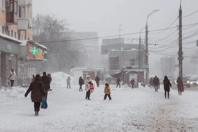 a bunch of people that are walking in the snow