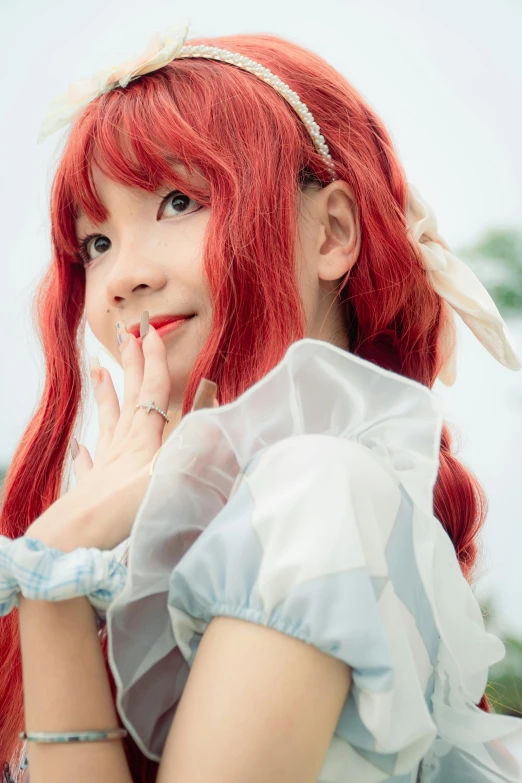 a girl with red hair posing in white dress