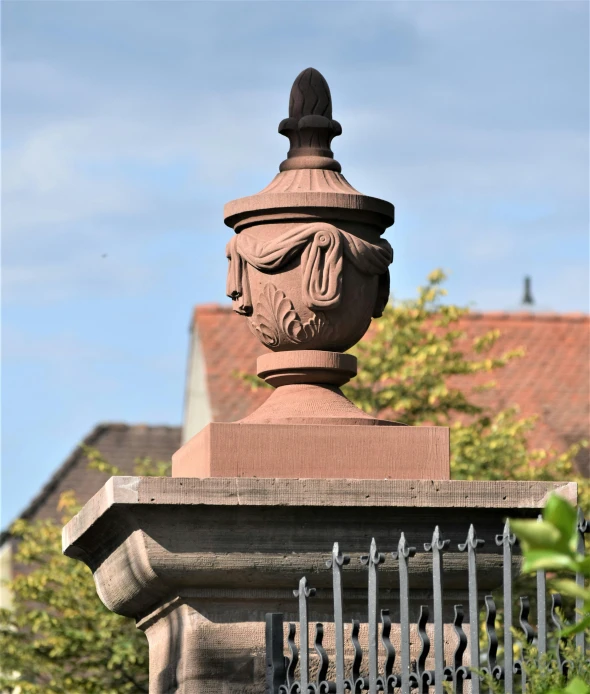 a statue is on the top of a fence