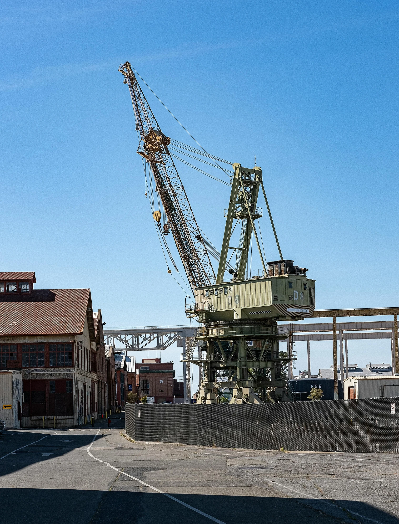 an old crane is still on its stand