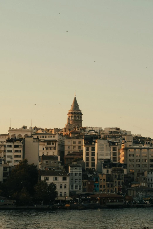 a small tower is above the city and water