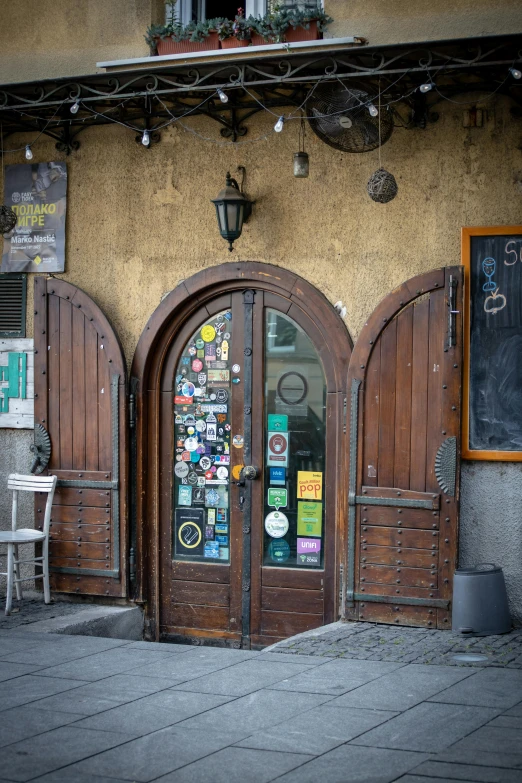 the outside of a restaurant with brown doors