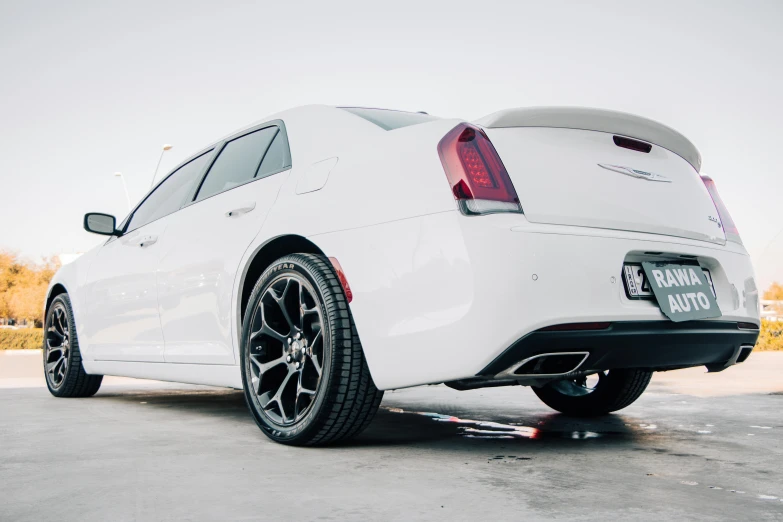 a white sports car parked on the side of a street