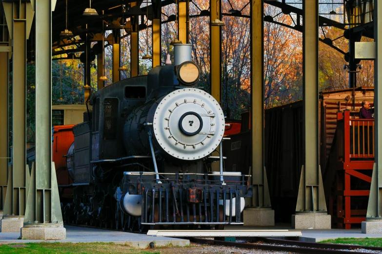 a black train sitting inside of a train station