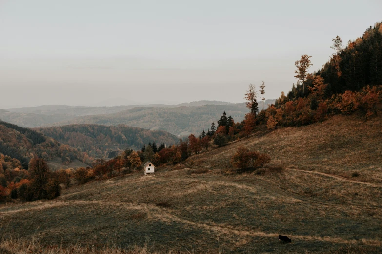 the house sits at the edge of the mountainous hills