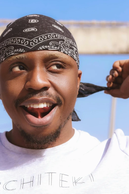 a black man with a bandanna around his head