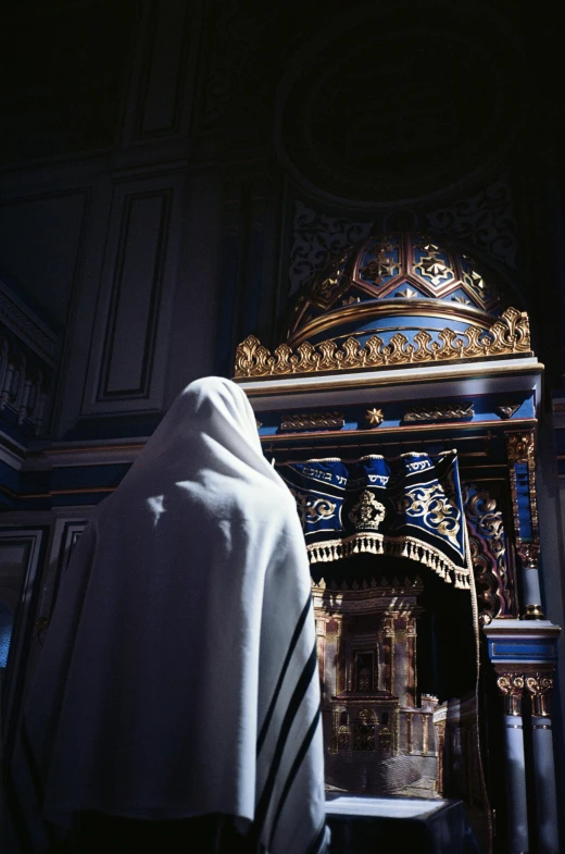 the nun is walking toward a beautiful alter