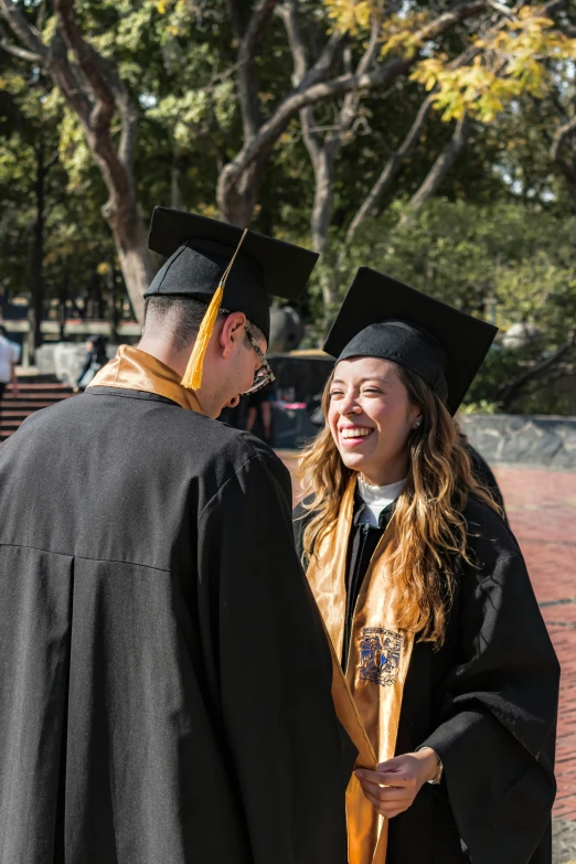 a graduate shaking hands with an unidentifiable student