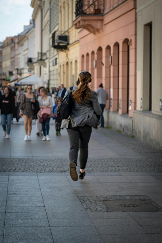 woman walking down the street carrying her suitcase and smiling