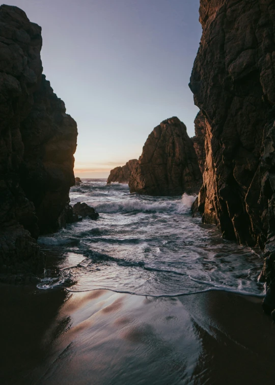 a view of a body of water in front of some rocks