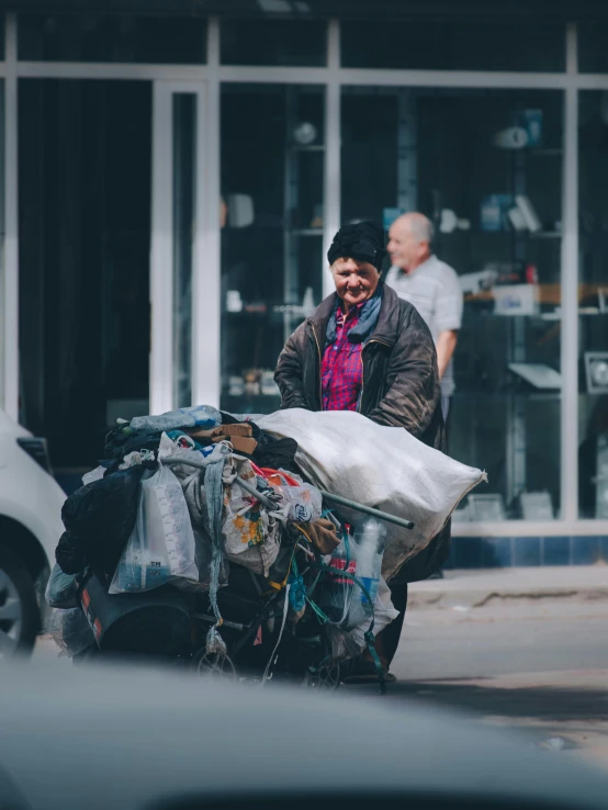 a man is pulling his garbage through the street