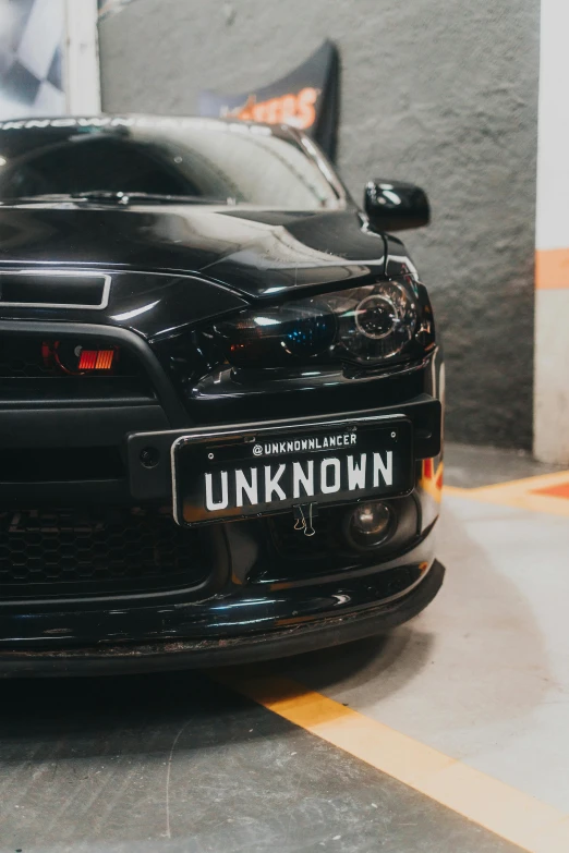 the car is parked in the parking lot with its license plate showing