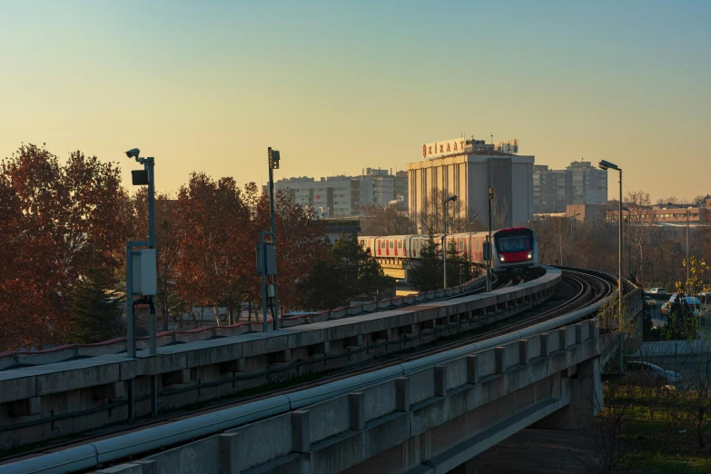 a cityscape is shown with a train on the track