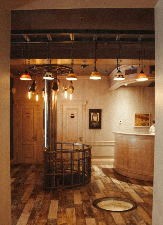 inside a public building, with several lamps, bars and wooden tables