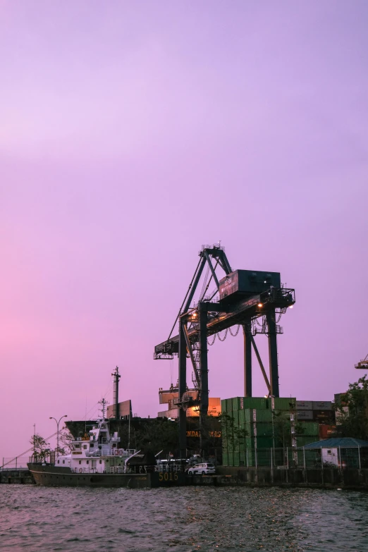 the cargo ship is loading containers on the dock