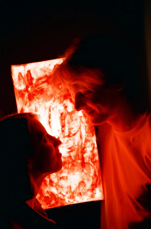 two people standing in front of an orange square