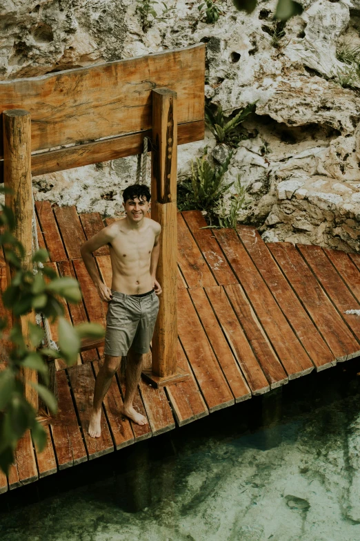 a man stands at the edge of the water