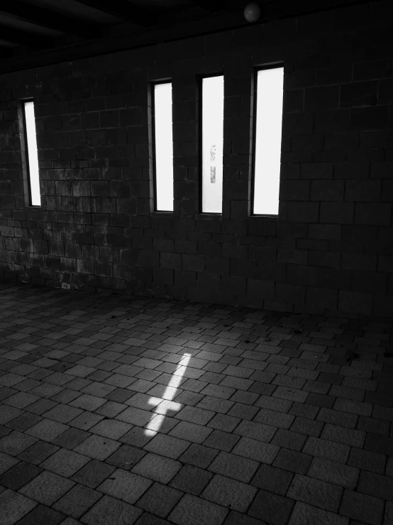 an empty room with windows and a checkered floor