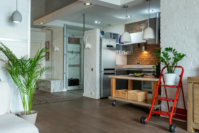 the kitchen is a modern space and is equipped with a table with two baskets for plant life