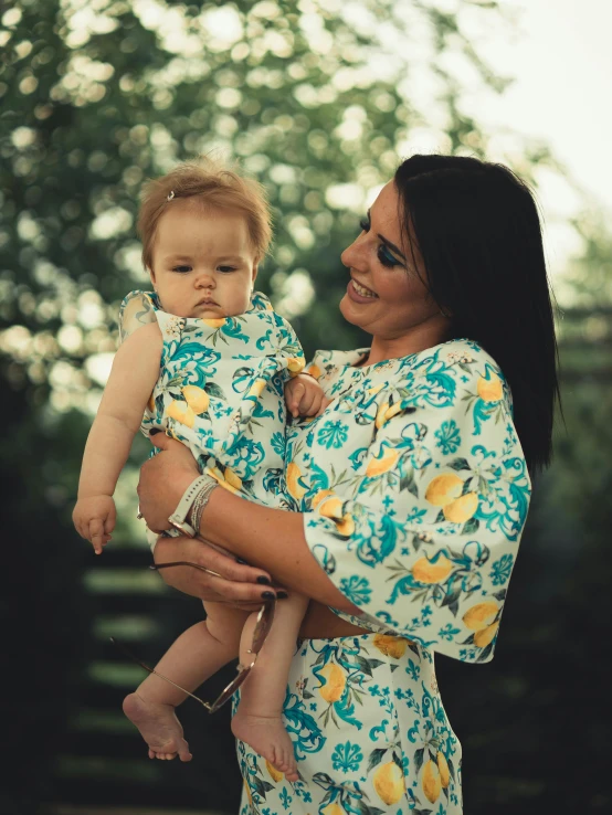 a woman holding a baby in her arms