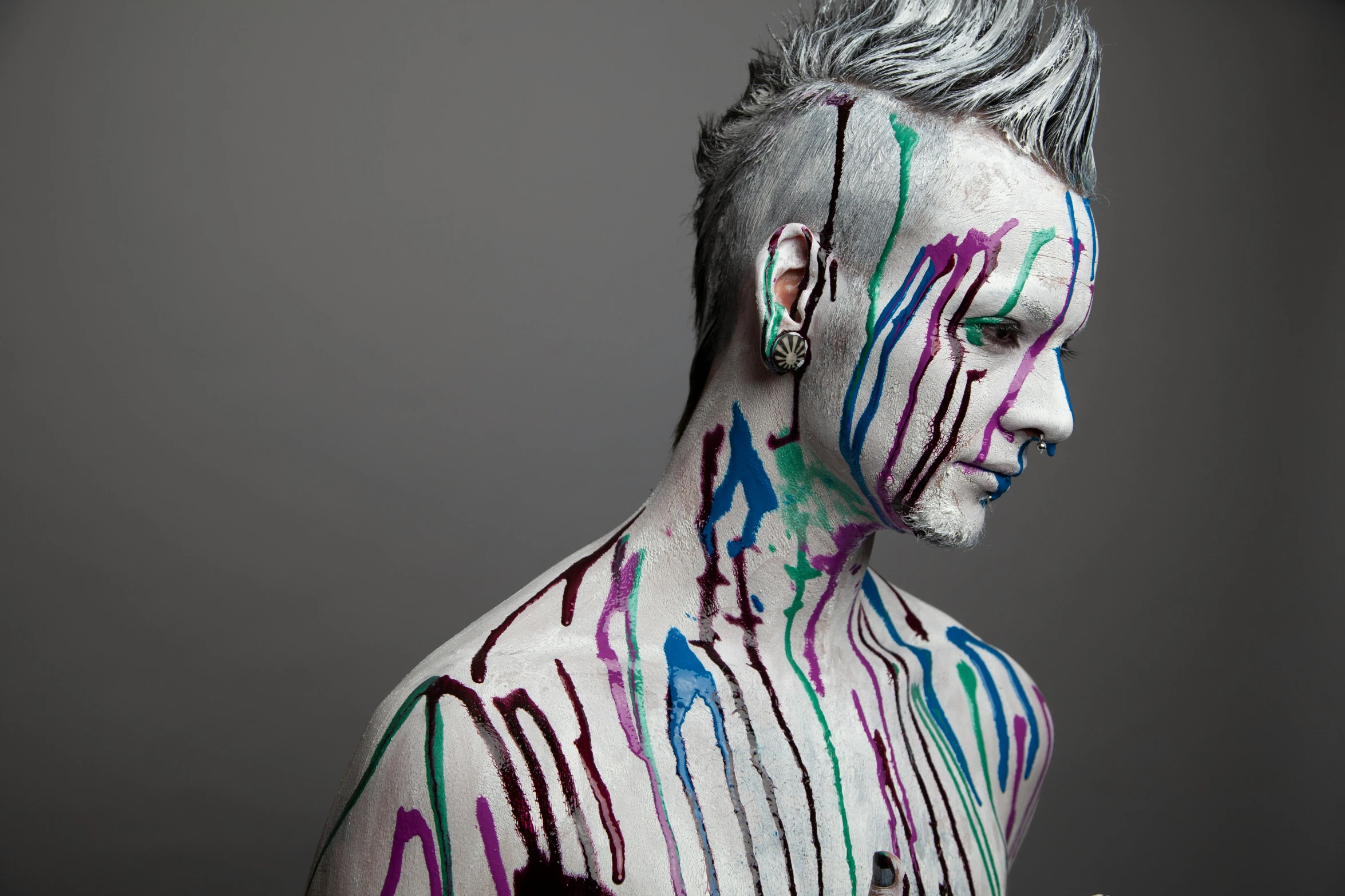 the man with painted hair is posed in his artistic fashion