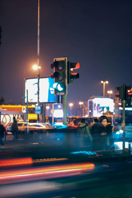 cars streak through the streets and blur pedestrians