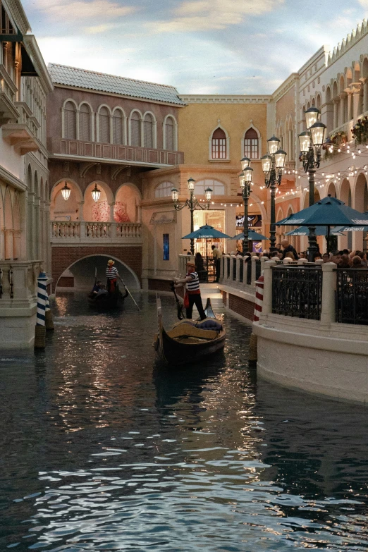 an ornate building with a canal passing by and a couple of small boats floating on the water