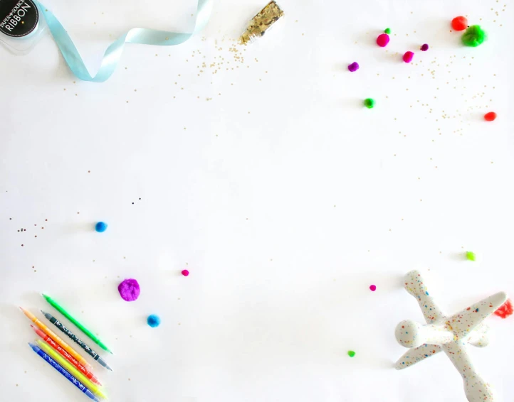 confetti sprinkles and colored pencils surround the backdrop for this diy craft