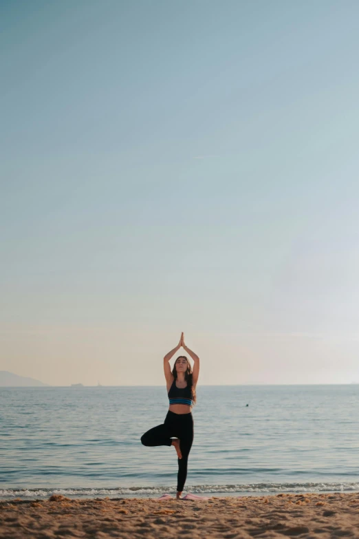 a person standing on a beach near the ocean