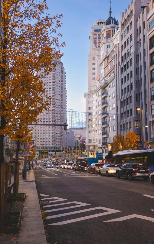 the city street is busy with people and cars